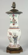 A LARGE CHINESE FAMILLE ROSE PORCELAIN VASE LAMP, the body painted with potted flowers, vases and