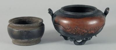 A CHINESE BRONZE TWIN HANDLE CENSER, with relief decoration of stylised waves and raised on three