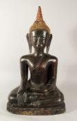 A LARGE TIBETAN SEATED BRONZE BUDDHA with gilded head piece, 77cm high.
