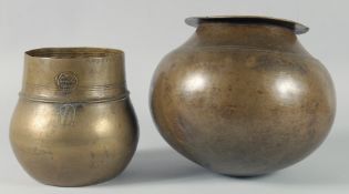 A LARGE AND HEAVY BRASS GLOBULAR BOWL, together with another inscribed brass bowl, larger approx.