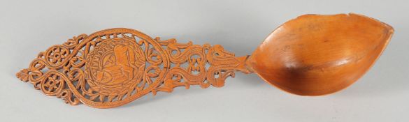 A 19TH CENTURY PERSIAN QAJAR CARVED FRUIT WOOD SHERBET SPOON, 28cm long.