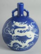 A CHINESE SACRIFICIAL BLUE AND WHITE PORCELAIN TWIN HANDLE MOONFLASK, with carved dragon and scale-