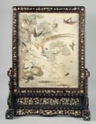 A GOOD QUALITY CHINESE EMBROIDERED SILK PICTURE INSET WITHIN A HARDWOOD SCREEN, depicting a