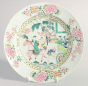 A CHINESE FAMILLE ROSE PORCELAIN PLATE, painted with a figure on horseback with a floral border,