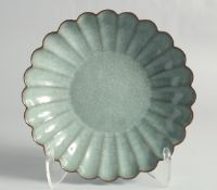 A CHINESE CELADON CRACKLE GLAZE RIBBED CIRCULAR DISH, 24cm diameter.