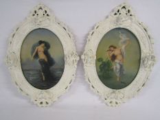 Pair of oval frames with cupid moulding depicting semi nude females, signed R.Wilson approx. 22.