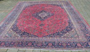 Very large pink ground Persian Kashmir carpet with traditional floral medallion 375cm by 285cm
