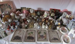 A large collection of elephants to include mirror, clocks, plaques and ornaments etc