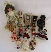 Collection of vintage dolls to include a black doll with grass skirt and national dress dolls