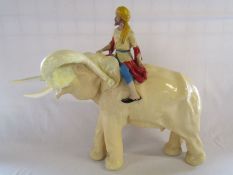 A large plaster elephant and mahout - has seen some repair