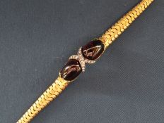 Victorian stone set bracelet consisting of two oval cabochon garnets interspersed with diamonds