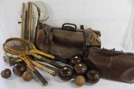 Large leather Gladstone bag containing tennis rackets, cricket stumps and wooden green bowls and a
