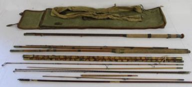Collection of vintage fishing rods including cane with brass with canvas carry bag and a gun