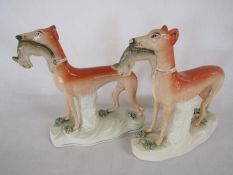 Pair of Staffordshire greyhounds with rabbits