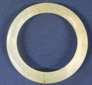 Jade type slave bangle, mottled pale green colour with brown inclusions , internal diameter 6.5cm