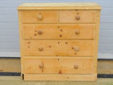A stripped pine chest of two over three drawers having matching turned handles, slightly a/f,