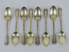 A set of eight HM silver teaspoons having scrollwork border and clamshell pattern handle,
