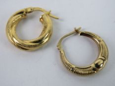 A single 18ct gold hoop earring, 1.2g, together with a single 9ct gold hoop earring, 0.5g.