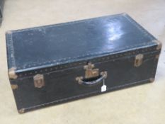 A black painted trunk having stud work and corner bracing, leather end handles, 84 x 47 x 28cm.