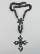 A 19th century Berlin Iron necklace bearing Gothic arched cross with profile over,