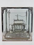 A hand made tin model tram car complete with driver and pantograph, having glazed windows,