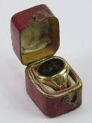 A 15ct gold signet ring having oval bloodstone bearing coat of arms featuring a Horses head out of
