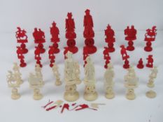 A 19th century Cantonese carved and red stained ivory chess set; one half red stained,