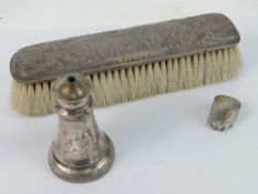 A HM silver backed brush having cherubic design upon,