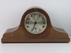 A c1930s Napoleon hat mantle clock having silvered dial with Roman numerals,