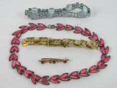 A vintage 9ct gold bar brooch set with three pink oval cut stones, slightly a/f, marked 375, 1.4g.
