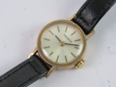 A 9ct gold Ladies Tissot wristwatch, manual, silvered dial, hallmarked 375, case back weighing 1.7g.
