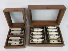 Two glazed top mahogany boxes each containing a quantity of vintage brass and ceramic electrical