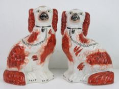 A pair of Staffordshire King Charles spaniels, each standing 22.5cm high.
