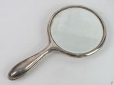 A HM silver dressing table hand mirror, hallmarked for Birmingham.