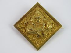 A late 19th / early 20th century Tibetan brooch in untested gilt metal,