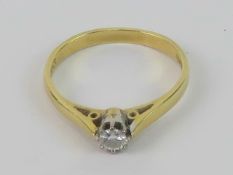 An 18ct gold diamond solitaire ring, round cut in white metal claw setting,