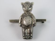 A HM silver teddy bear rattle converted for use as a brooch, Chester hallmark, 4.2cm high.