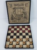 A late 19th century 'Travellers Set of Ivory Draughts' measuring 13.5 x 13.5cm in original box.