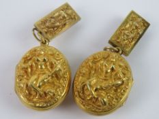 An unusual pair of late 19th / early 20th century Tibetan lockets in untested gilt metal,