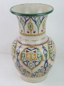 A hand painted pottery vase standing 41cm high.