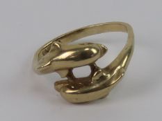 A 9ct gold ring in the form of two leaping dolphins, hallmarked 375, slightly a/f, size approx N, 3.
