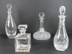 Two Edinburgh crystal decanters together with an 'Atlantis' square shaped decanter and another