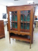 A good Edwardian two door display cabinet strung and cross banded mahogany,