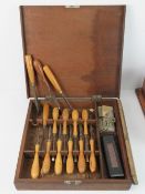 A boxed vintage set of woodworking chisels with sharpening wet stone within original Abel wooden
