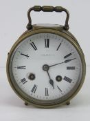 A good eight day striking enamel dial brass 'porthole' clock with swing handle,