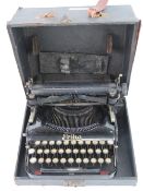 A vintage c1920-40s Erika folding typewriter having keys, ribbon and original box.