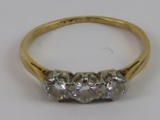 A vintage three stone diamond ring, set in white and yellow metal,