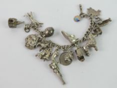A charm bracelet with a large selection of silver and white metal charms upon including Noahs ark,