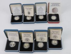 Silver proof one pound coins; 2000 (x2), 1987, 1983, 1986, 'Leek reverse', 1984, and 1988.