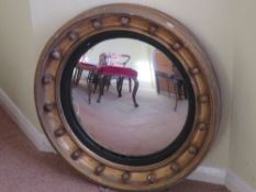 A fine late 18thC circular bullseye wall mirror. Gilded and with decorative spheres throughout.